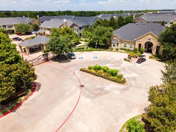 A residential area with houses and a parking lot.
